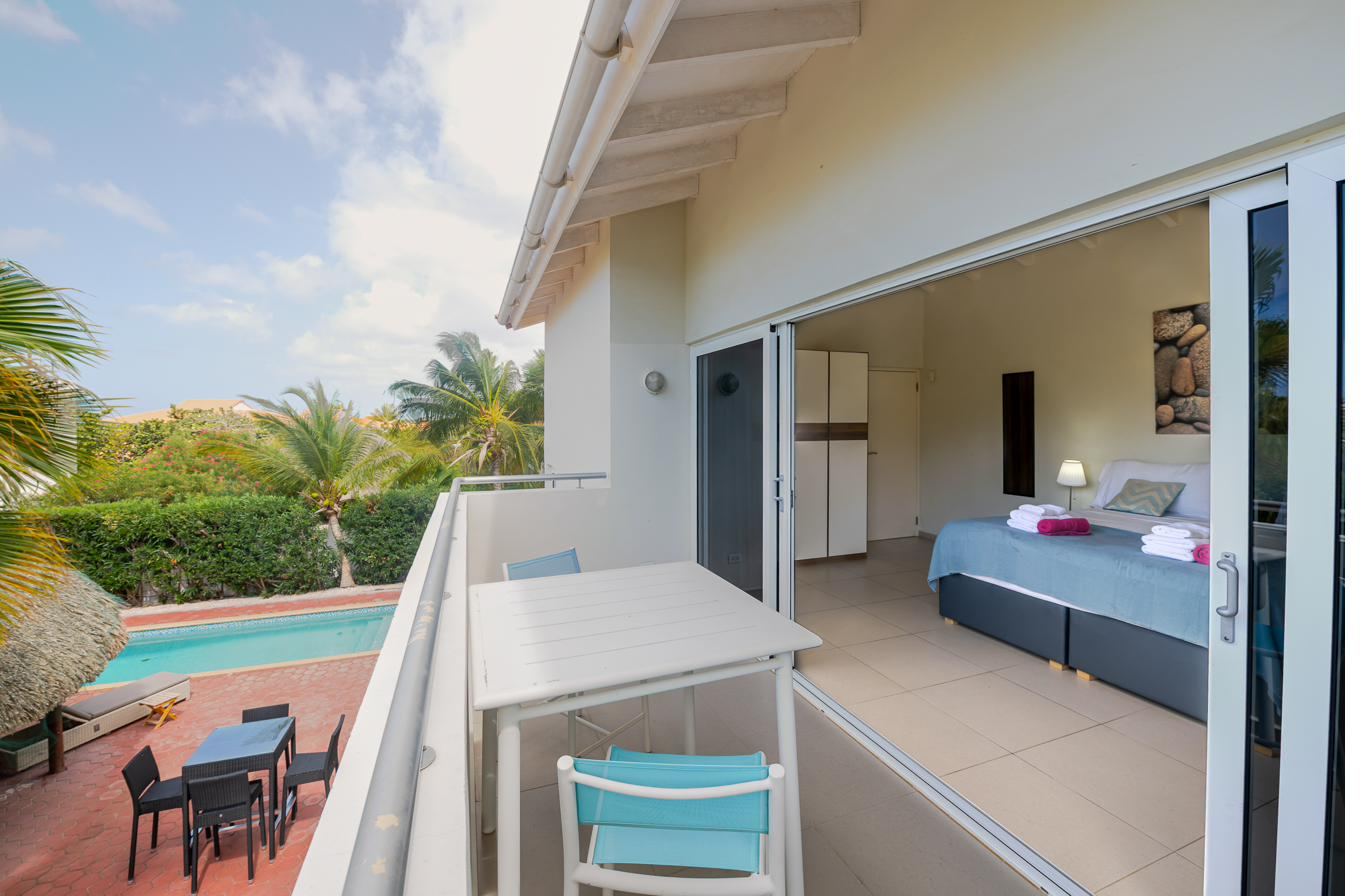 View from the master suite balcony over the pool and garden