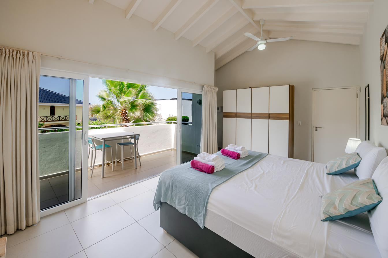 Upstairs master bedroom with doors to a private balcony